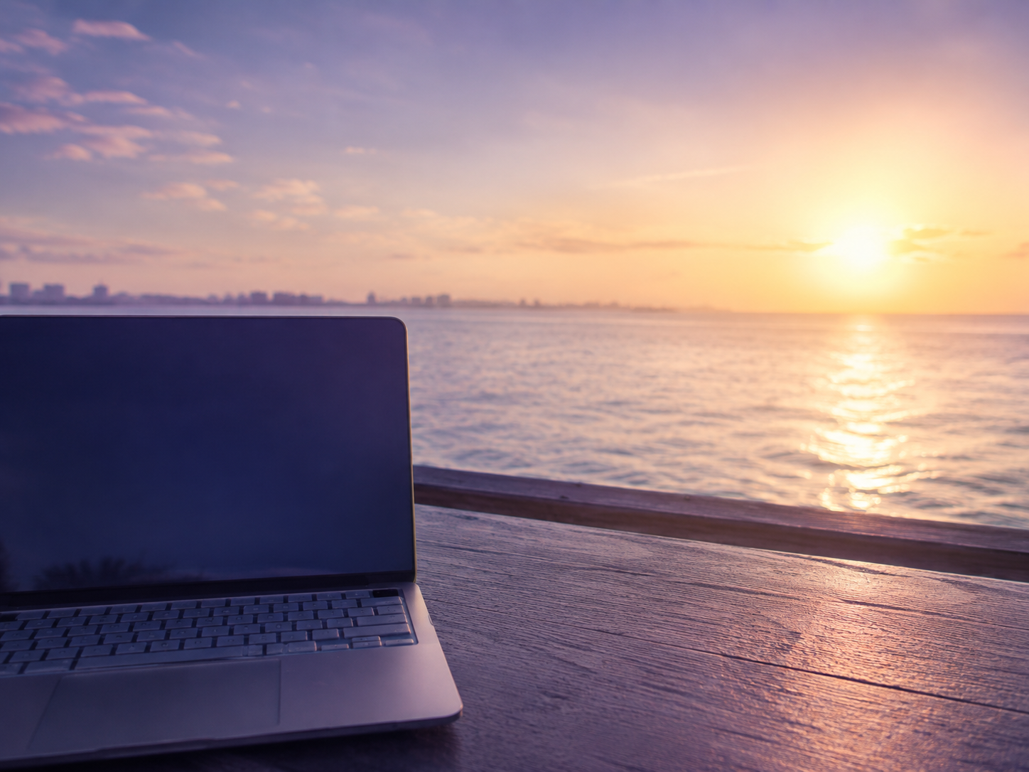 Laptop overlooking the ocean representing telehealth care